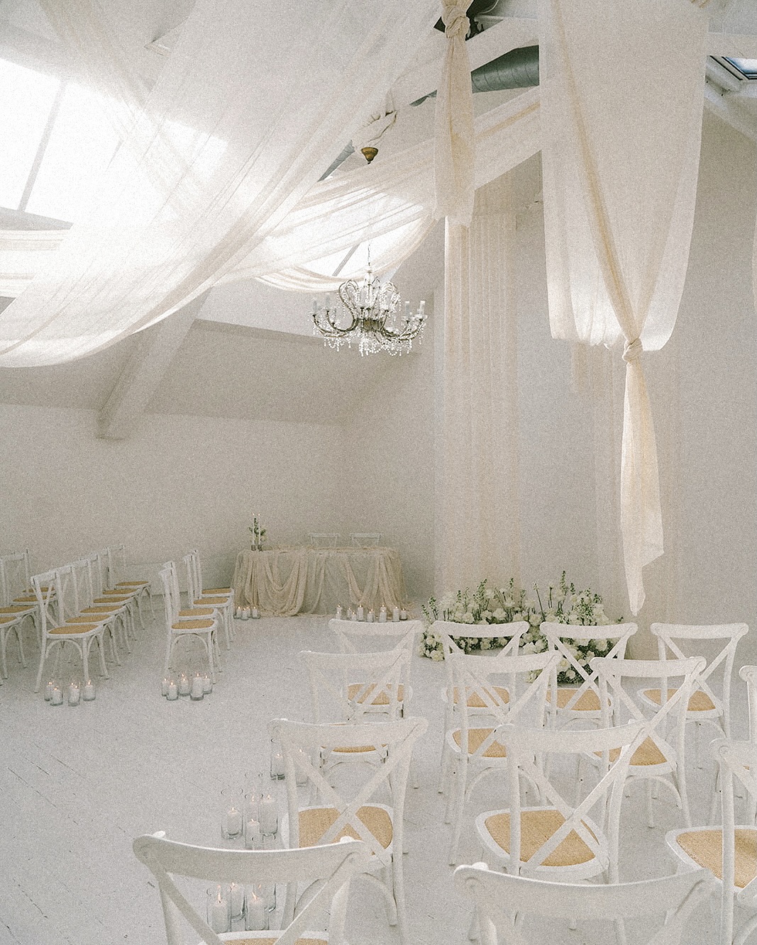 Saying ‘I do’ in style 💍✨

A timeless ceremony backdrop of hanging fabric installations, crystal chandelier & delicate floral arrangements - bathed in warm candlelight 🕯️

photography @dan.mccourt 
styling @floveevents 
florals @flower_lounge 
draping @miasylviaa 
furniture @chairmanhireuk 
chandelier @stockyardnorth 

#wedding #ceremony #venue #fivefourstudios